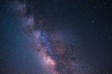 A star-filled night sky featuring the Milky Way, Jupiter, and meteors streaking by