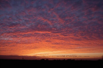 Vibrant Evening Sky with Dark Silhouetted Land - Scenic Horizon Landscape