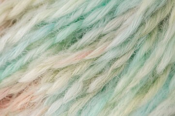Obraz premium Close-up of vibrant yarn strands on a plain backdrop