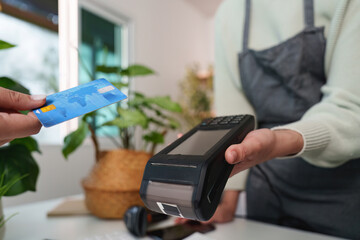 Contactless Payment. Customer using credit card for transaction at retail store.