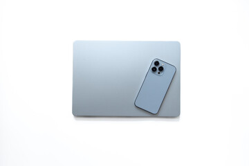 Obraz na płótnie Canvas Blue silver laptop and phone on white background, top view