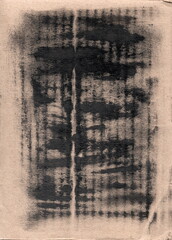 An abstract print of black paint on rough, light brown paper. The vertical and horizontal traces create a rhythmic grid reminiscent of an antique print, eroded by time, or a copy from a worn stencil. 