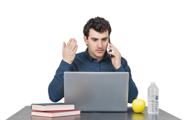 Furious young man seated at the working desk looks frustrated talking on phone and gesturing with his hand. Mad male portrait isolated on transparent background