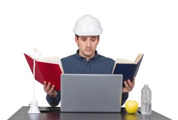 Stressed young man engineer wearing white helmet, sitting at the working desk looks confused in his laptop as holds books in both hands, isolated on transparent background