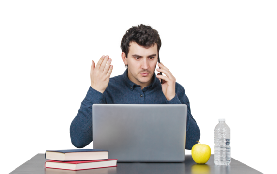 Furious young man seated at the working desk looks frustrated talking on phone and gesturing with his hand. Mad male portrait isolated on transparent background