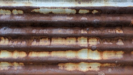 Old and rusty galvanized sheet metal wall, abstract rust pattern.