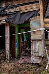 Broken doorway reveals a dark corridor of decay and forgotten history