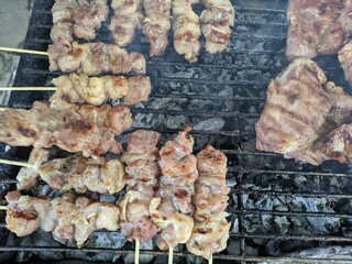 thai style grilled pork juicy meat sizzlingon on the grill