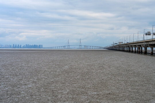 suspension bridge on the sea, and mudflat beach on a cloudy day