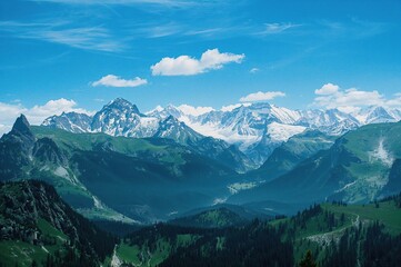 Snowy mountain landscape with blue sky and rocky peaks