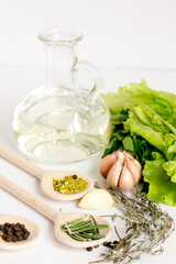 olive oil and spices on white background