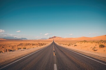 Fototapeta premium Empty asphalt road stretching through a scenic landscape