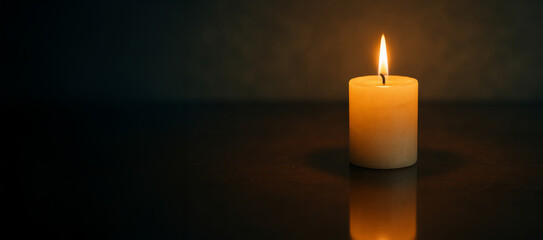 Candlelit serenity with simple composition featuring a single candle glowing in the dark. concept of tranquility, warmth, and peaceful reflection in minimalist decor