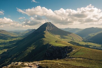 Fototapeta premium View of a prominent mountain peak from a nearby summit in the summer season
