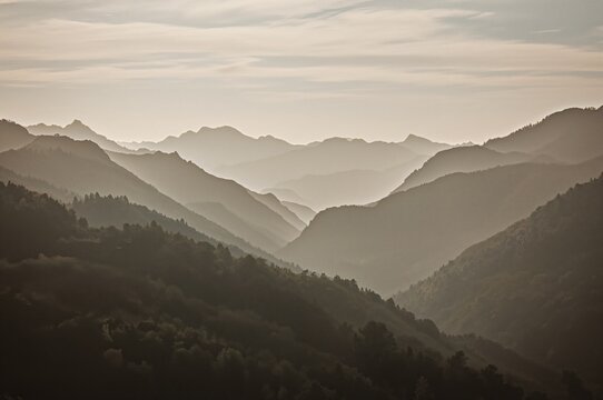 Mountain layers with mist filling the valleys, vintage cross-processed filtered photo