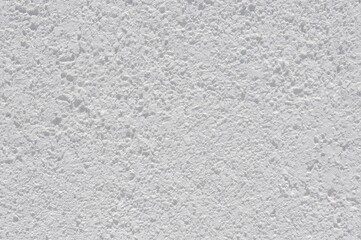 Fototapeta premium White textured facade coating. Acrylic textured plaster. Granular lamb plaster finish.