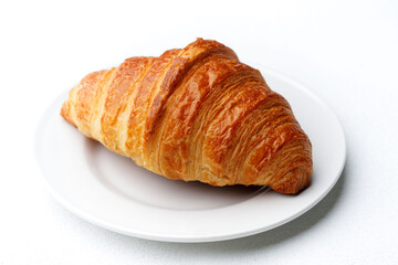 Classic French Butter Croissant on a White Plate