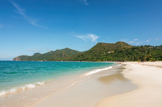 Scenic outlook of a coastal beach with rocky cliffs and clear waters