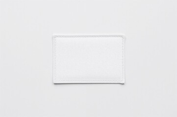 White rectangular badge featuring white edging