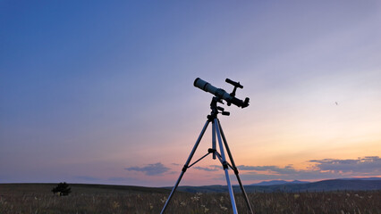 Preparing for night sky observing with a astronomical telescope just before sunset in the...
