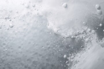 Light-colored design featuring water droplet background