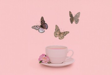Vintage teacup surrounded by butterflies against a soft pastel backdrop. Retro 80s and 90s style with a romantic spring or summer vibe. Minimalistic fashion and love theme.