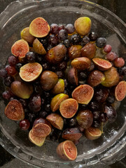 Baking a mix of figs and grapes with spices and feta cheese - dinner preparation - dessert or main dish 