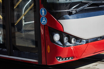 Fototapeta premium Red bus for public transportation on city streets.