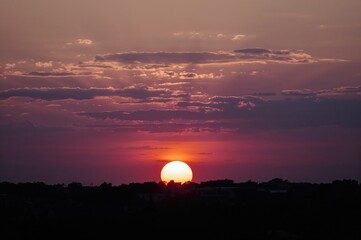 Sunset scene with the fading sun in the evening sky