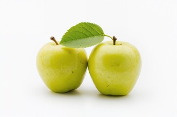 Two mature green apples accompanied by a leaf on a white backdrop