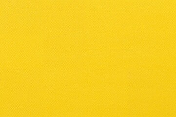 Naklejka premium Bright yellow backdrop with a gentle fabric pattern, ideal for artistic projects or digital applications.