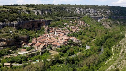 Aerial view of little town and the beautiful waterfall of Orbaneja del Castillo in Burgos, Spain.