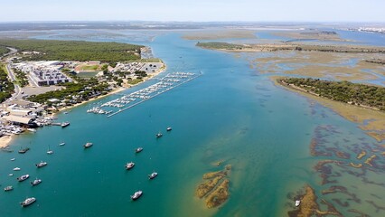 Aerial view over the village, marinas and fishing port of Punta Umbría, and the river Piedras, in the Atlantic coast of Huelva, Andalusia, Spain.