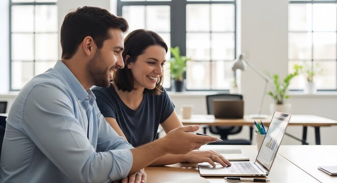 Young professionals collaborating on data analysis with a modern laptop in a bright office, driving business growth together now