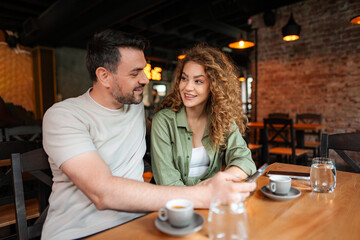 Couple enjoying coffee and conversation at a cafe table