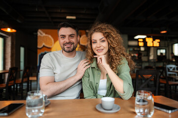Young couple smiling and posing in a restaurant