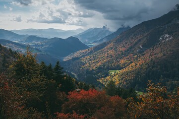 The grand peaks of the countryside, covered in lush greenery, offer a serene and breathtaking display of nature's beauty