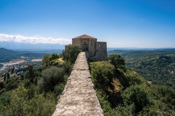 The fortress atop the hill protects against invasions from the valley below.