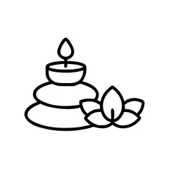 Spa candle on stacked pebbles with lotus flower  