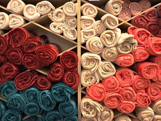 Colorful rolled plaid blankets in a home goods store — harmonious mix of beige, coral, burgundy, and blue hues creating a cozy and inviting aesthetic.