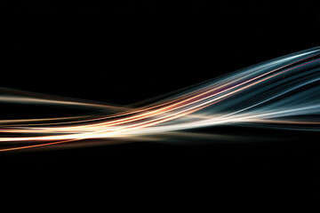 Light streaks flowing smoothly in dark space create elegant abstract background with warm and cool tones blending beautifully