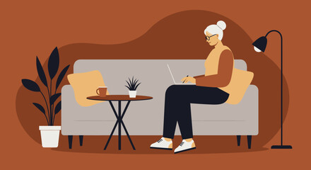 Senior woman using laptop at home working or learning remotely on a cozy sofa