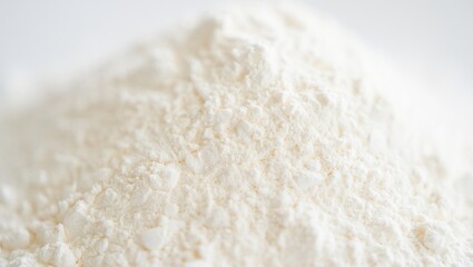 White wheat flour forming a textured heap, showcasing the essential baking ingredient's dry powdery detail crucial for preparing dough, cakes, and various culinary recipes