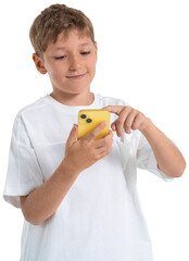 Cheerful boy in white shirt holding and using a yellow smartphone, isolated on white background,...