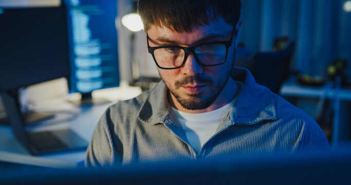 Closeup team adult male freelance work late typing write prompt AI bot app program nomad terminal code at office night. Artificial intelligence dashboard, robotics, user interface, machine learning.