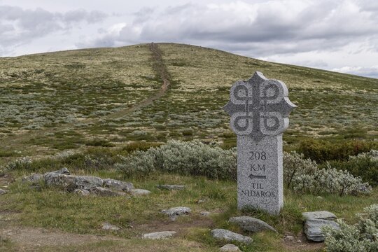 Steinerne Wegmarkierung oder Meilenstein mit Gravur '208 KM TIL NIDAROS', Olavskreuz f&uuml;r Pilger, historischer Kongsvegen oder K&ouml;nigsweg, Pilgerweg Olavsweg, Olavsleden oder Pilgrimsleden, Dovrefjell, Norwegen