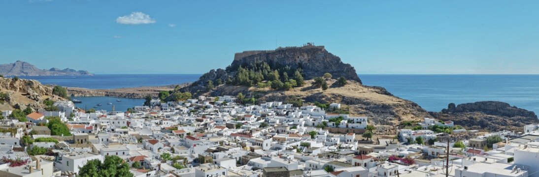 Panoramic view over the coastal landscape of Lindos with Acropolis and hills in the background, Acropolis, Lindos, Rhodes, Island, Greece