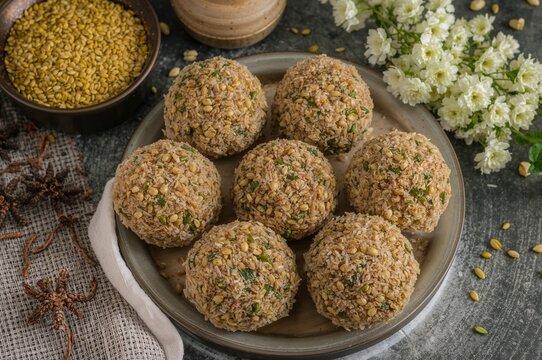 Nutritious Garden Cress Seed Sweet Balls, also known as Halim Ladoo or Aliv Laddu, ideal for winter and postpartum nourishment, traditionally served in a dish.