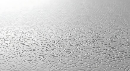 Close-up Of Embossed White Surface With Repeating Floral Pattern texture