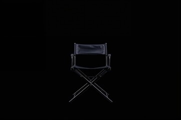 Single vacant director's chair against a dark backdrop